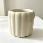 Glazed white ceramic planter with ribbed scalloped sides, no plant