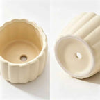 Cream ceramic planter base with drainage hole, underside view
