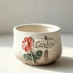 Speckled ceramic planter with Garden text and embossed red flower
