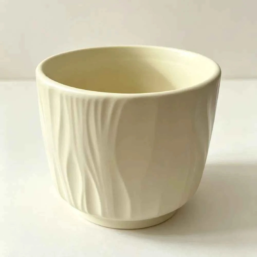 White ceramic planter with vertical ridges, empty bowl shape