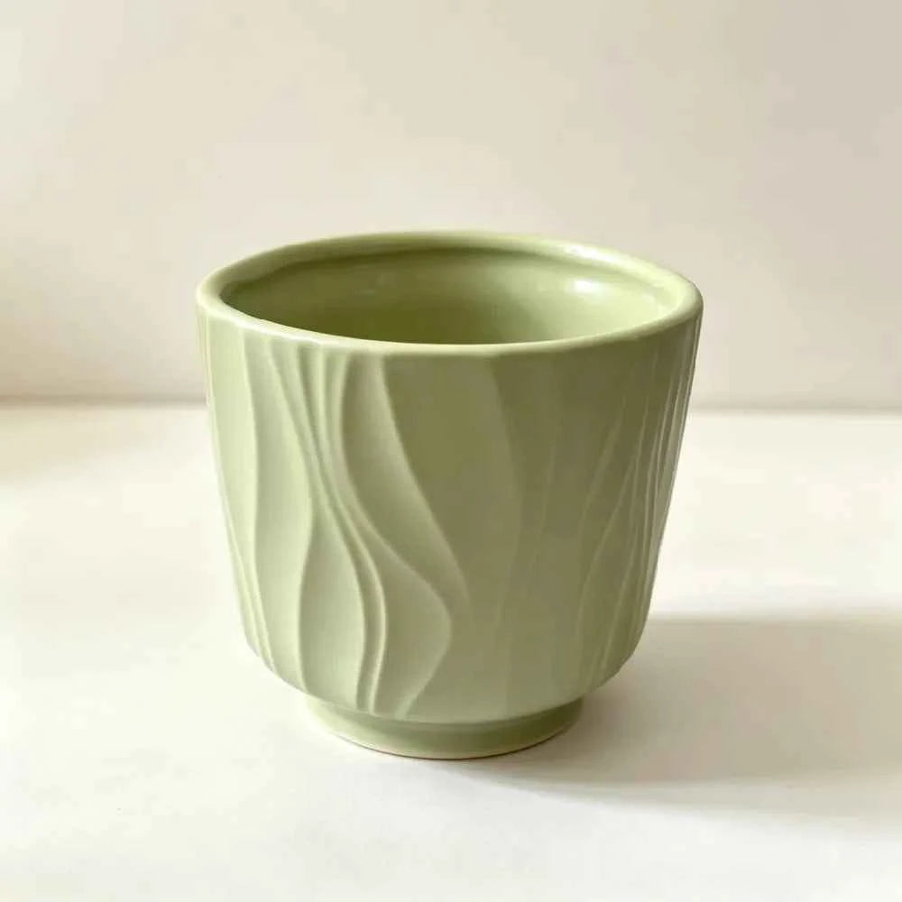 Sage green ceramic plant pot with embossed wave pattern