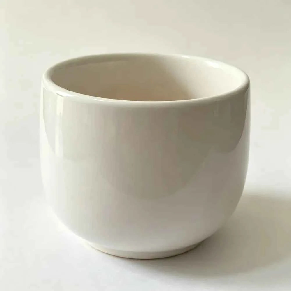 White ceramic planter with rounded bowl shape, empty interior