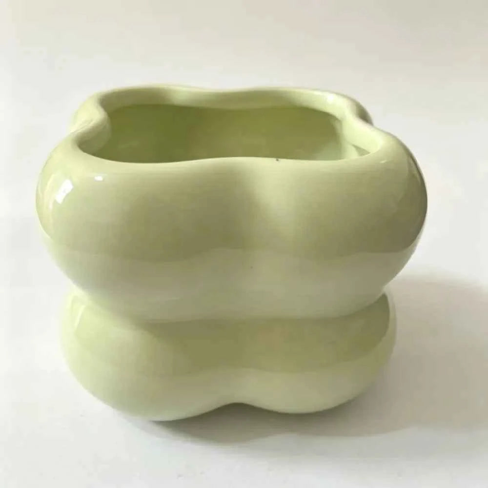Light green glossy ceramic planter with wavy scalloped rim, empty bowl