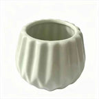 Light mint ceramic planter with scalloped vertical ridges, open bowl shape