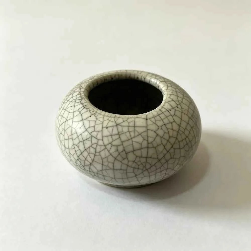 Low ceramic planter with cracked white glaze and open top