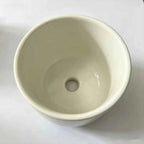 White ceramic planter interior with centered drainage hole