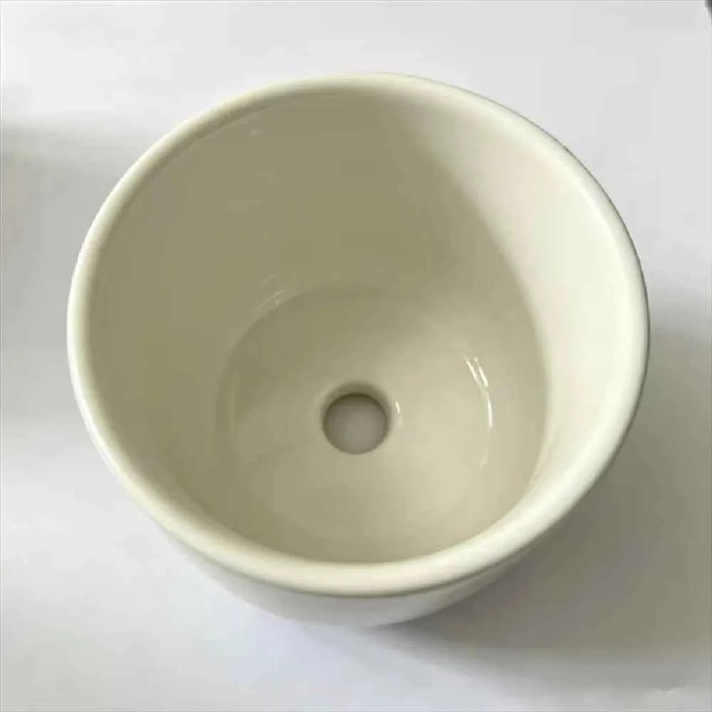 White ceramic planter interior with centered drainage hole