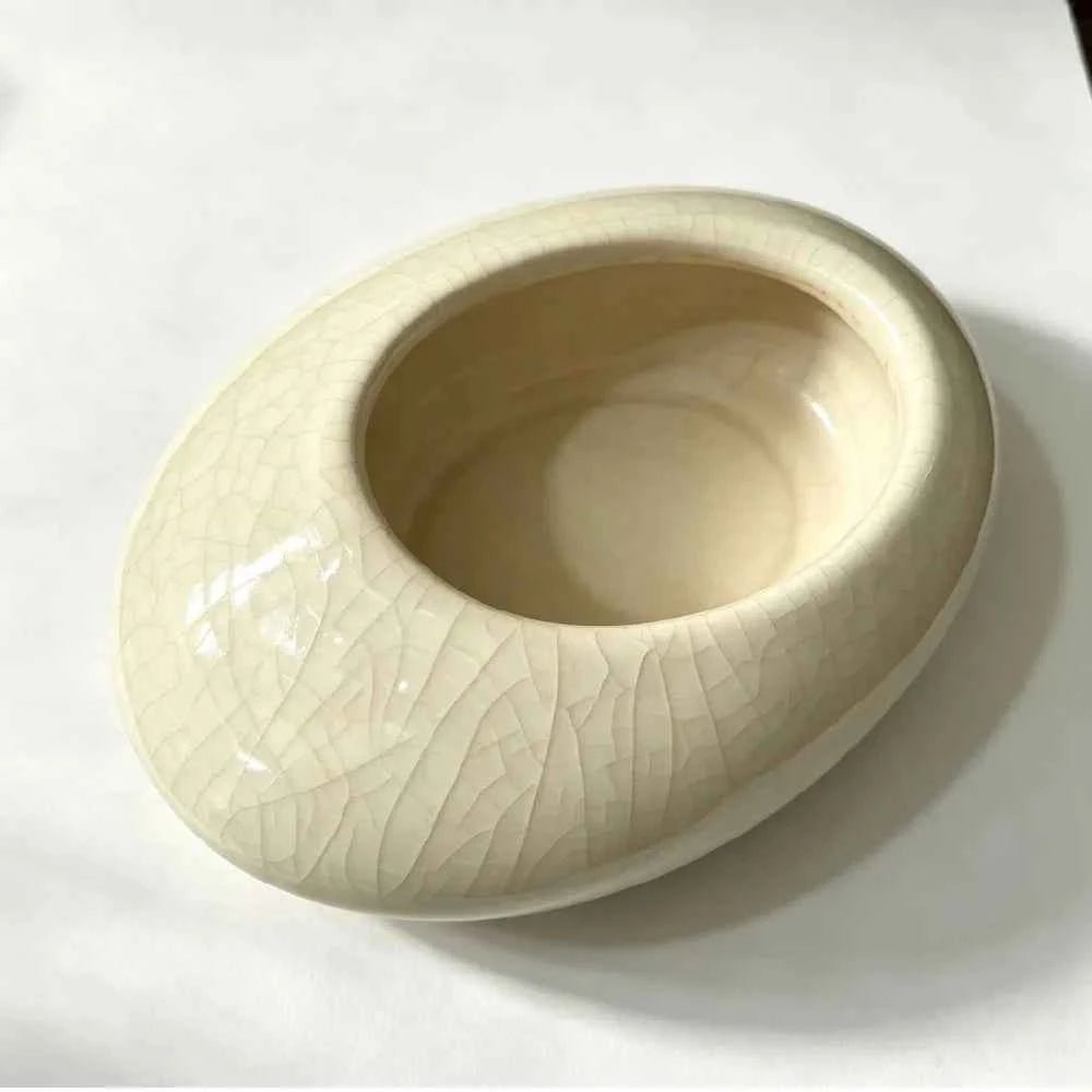 White shallow ceramic planter bowl with crackle glaze and wide opening, side view