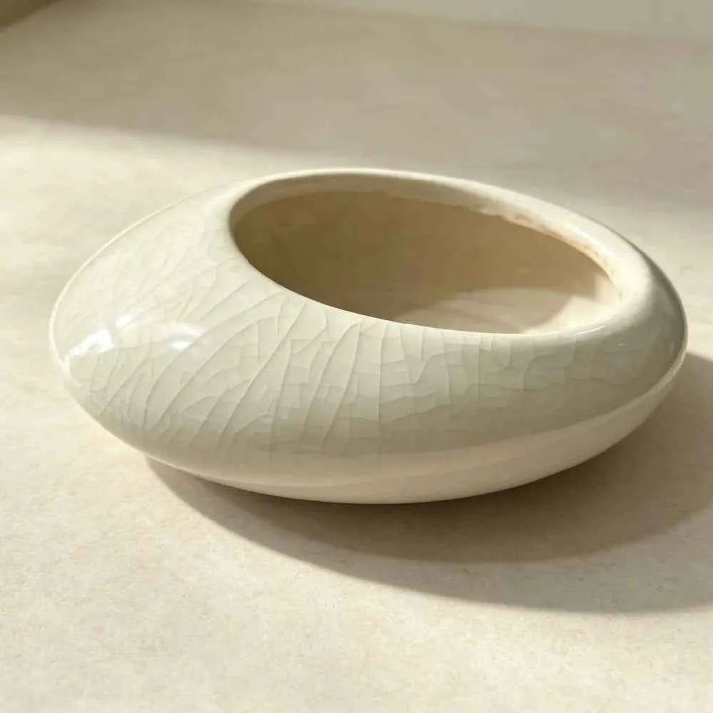 White shallow ceramic planter bowl with crackle glaze, empty interior